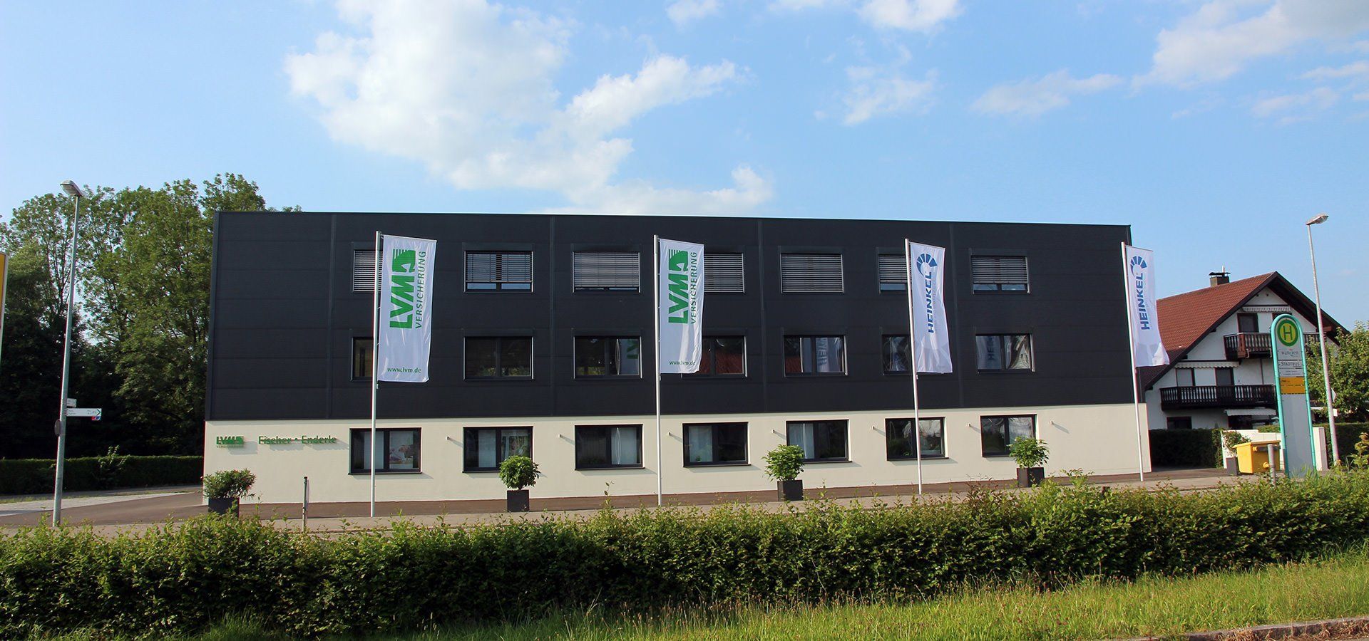 Fahnenmast vor einem Firmengebäude im Außenbereich